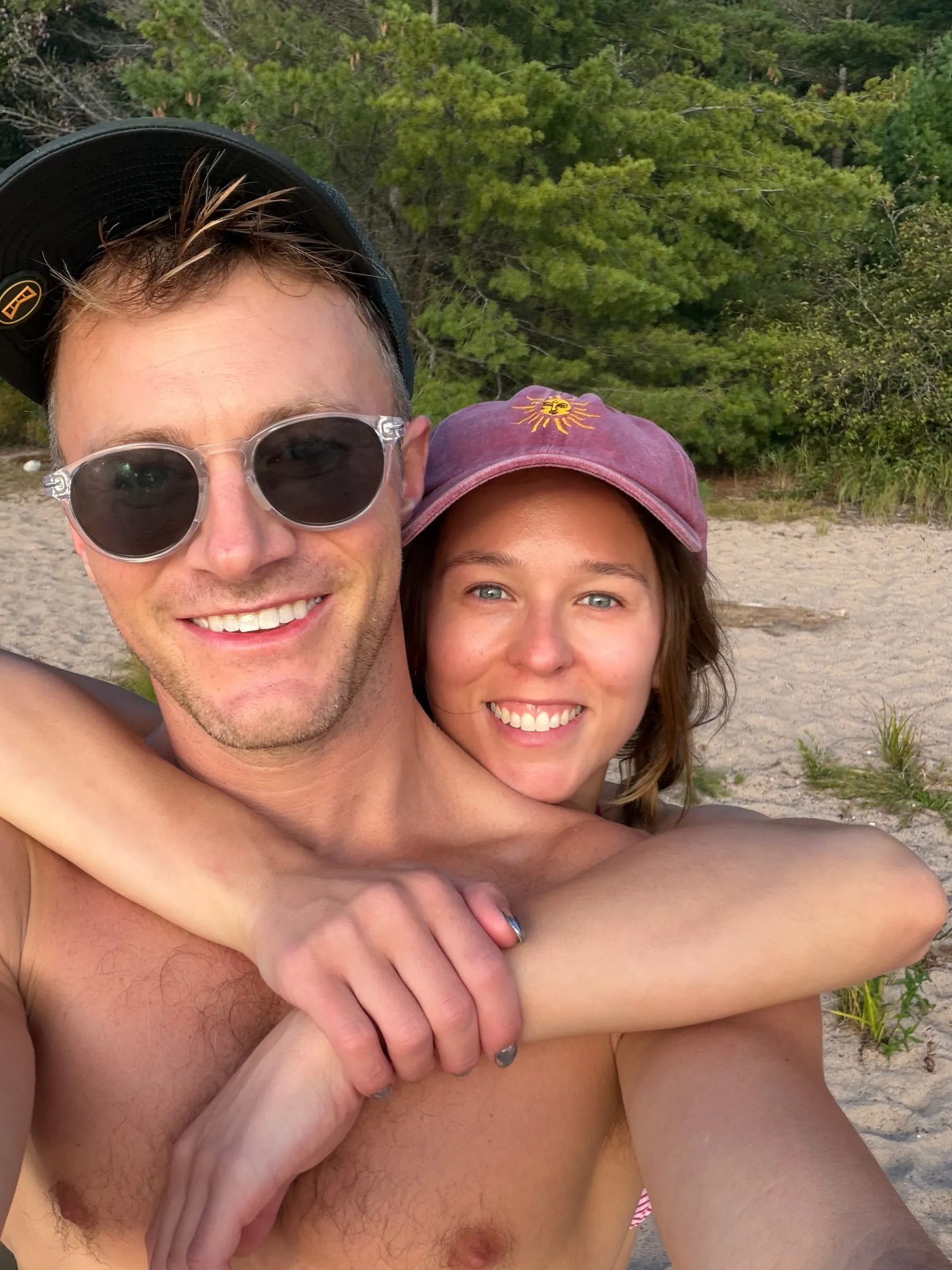 Kayla and David grinning in a beach selfie