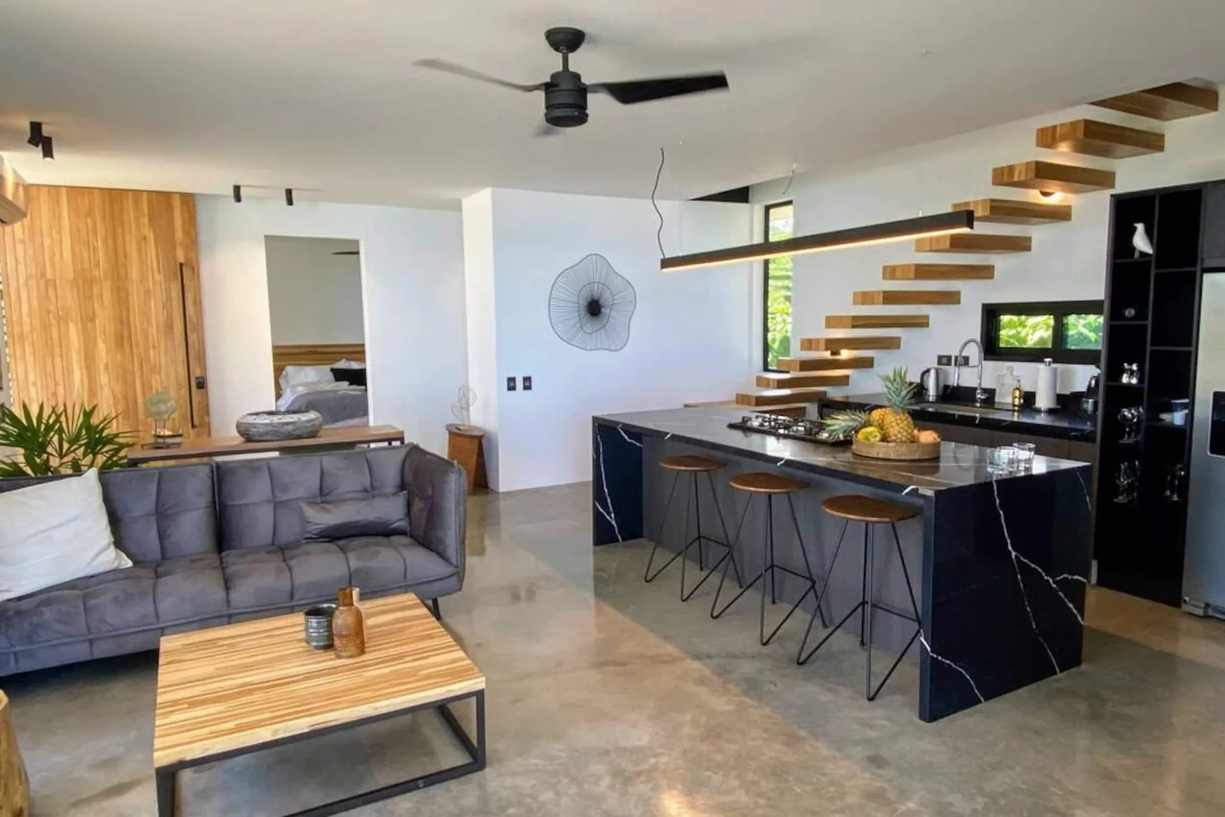 Kitchen and dining area with a floating staircase