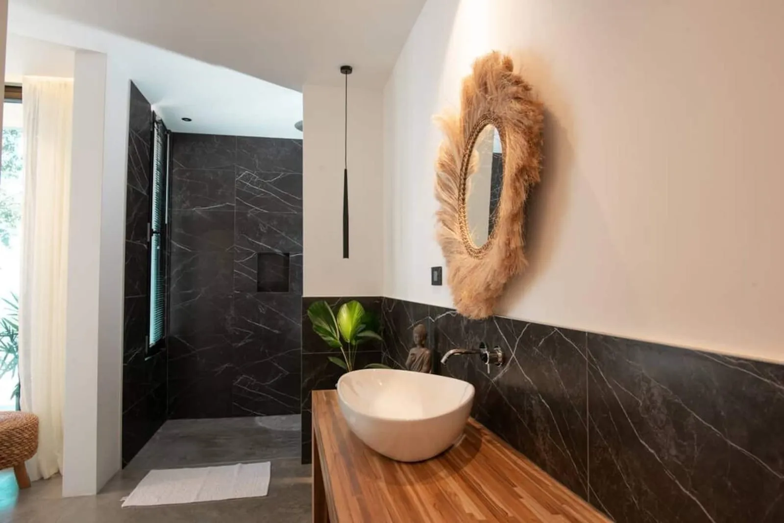 Bathroom with a woven mirror