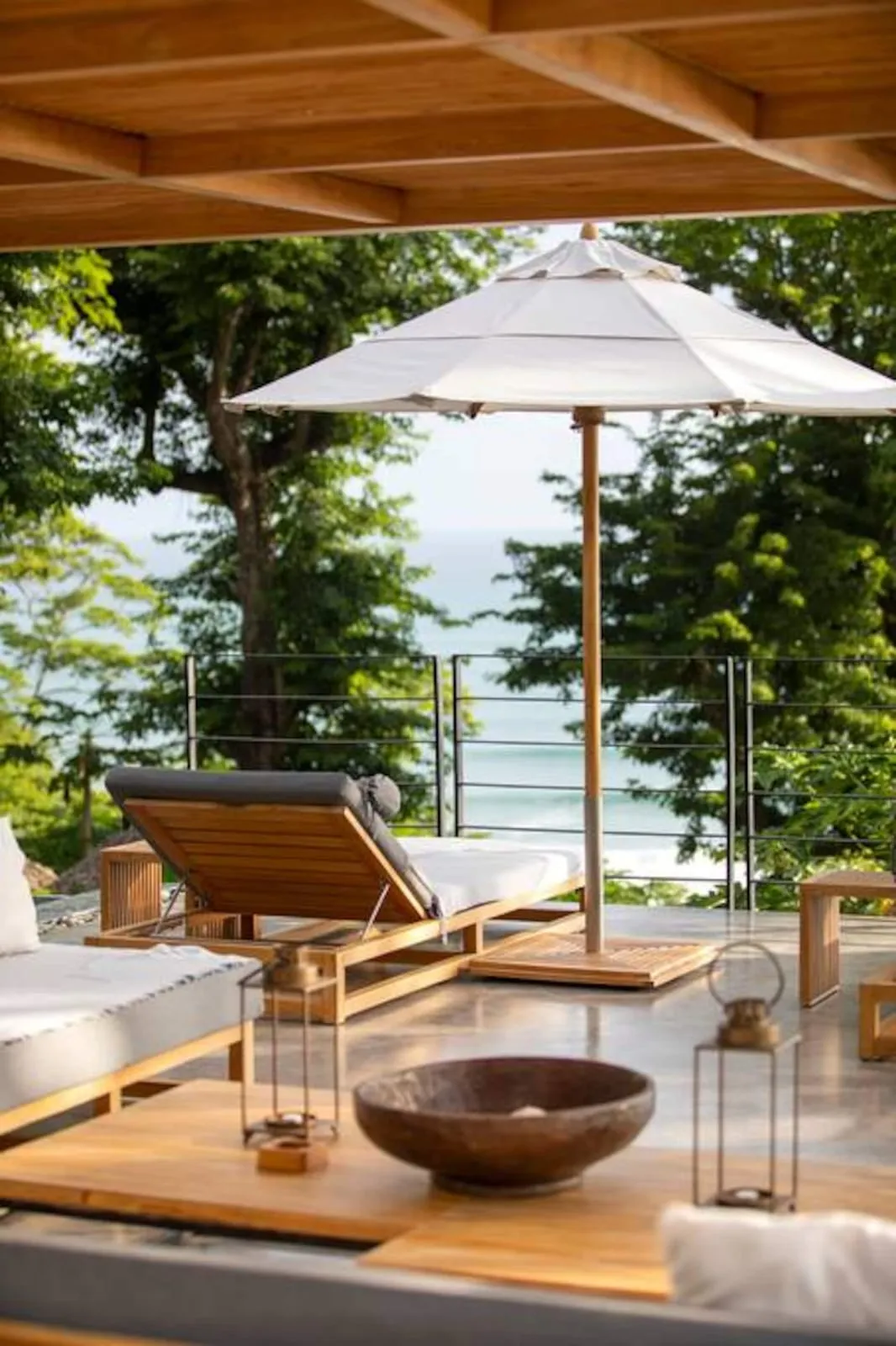 Lounger under an umbrella by the pool